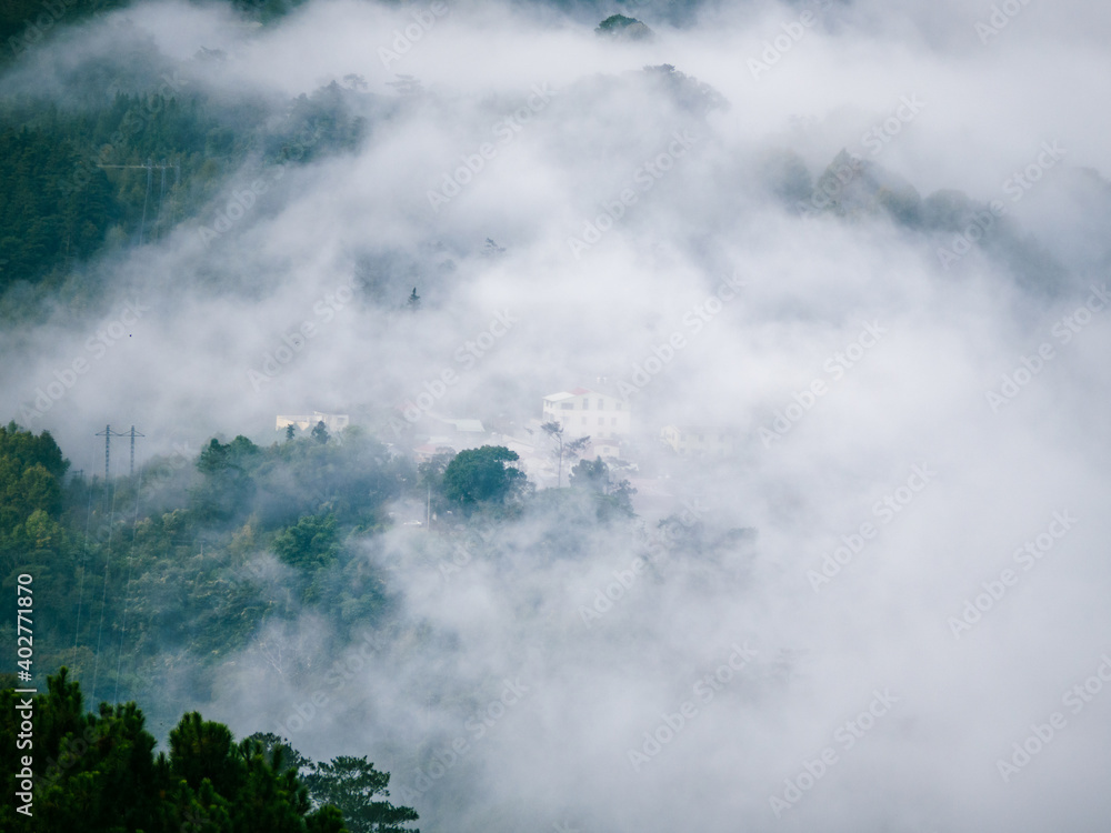 mist covering mountains and village