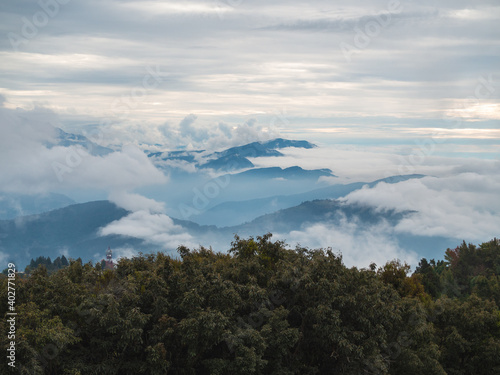 Fog and clouds are covering the forests and Layered Mountains