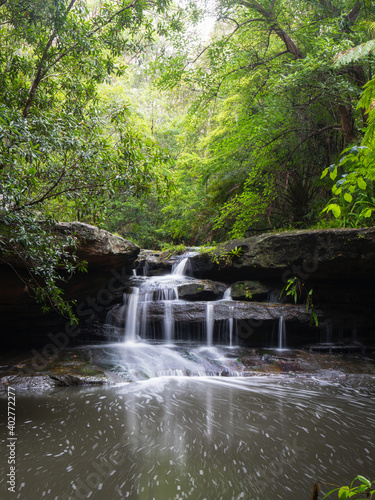 Small cascade waterfall in rainforest area.