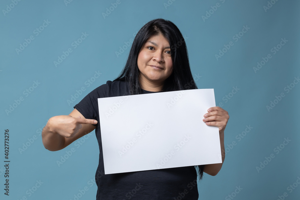 Your text here. Mexican Latin woman holding empty blank board. Studio portrait with blue background. Your text here. Mexican Latin woman holding empty blank board. Studio portrait with blue background.