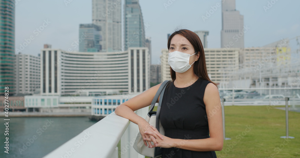 Woman wear face mask and look at the city view