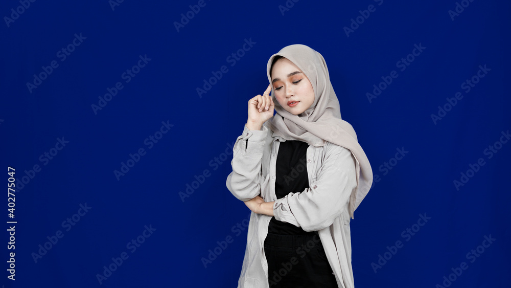 asian hijab woman thingking and get idea isolated blue background asian hijab woman thingking and get idea isolated blue background