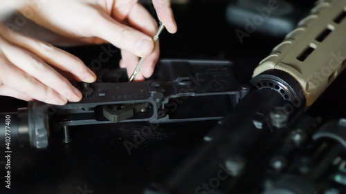Armorer gunsmith repairing and maintaining an AR15 Rifle.