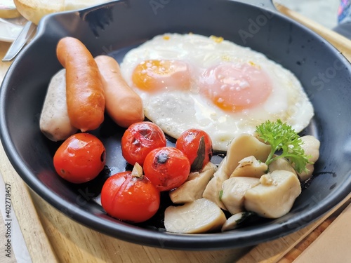 English breakfast - fried egg,tomatoes, mushrooms, and toast. Top view