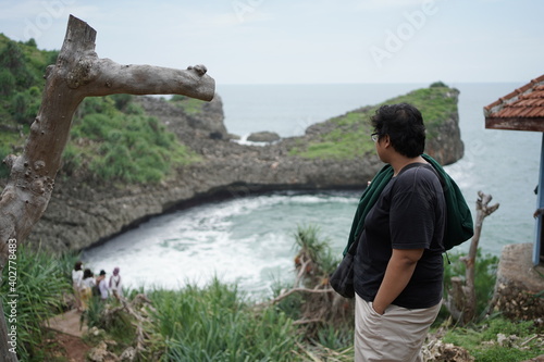 Tourists see the beautiful view of Kesirat beach, Gunung Kidul, Yogyakarta.