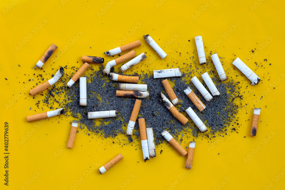 Smoked cigarettes on yellow background. Smoked cigarettes on yellow background.