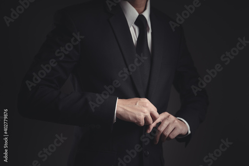 Close up shot of businessman in black suit.