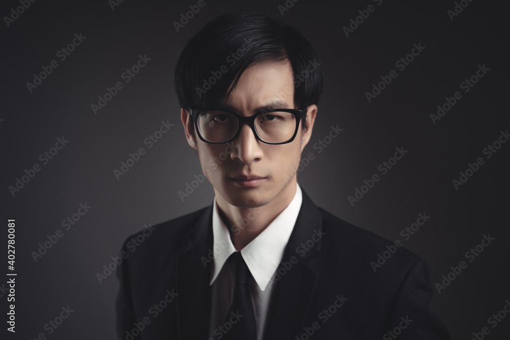 Portrait of Asian businessman in black suit.
