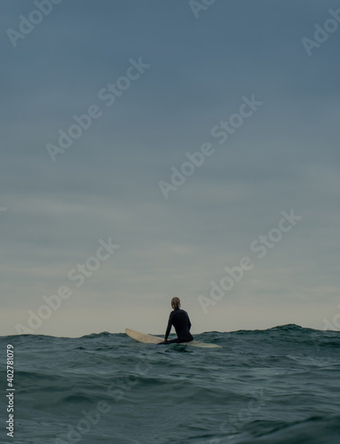 A Woman waiting for a wave to surf