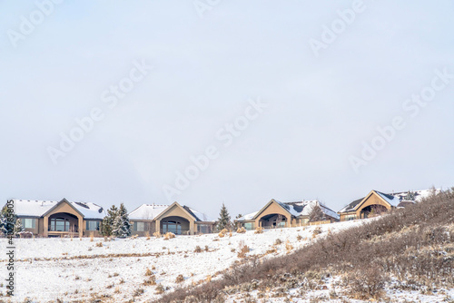 Facade of identical homes on a residential community built on snowy mountain
