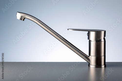 Faucet, chrome stainless metal faucet in bathroom or kitchen.