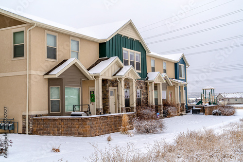 Apartments with gabled entrances on a snowy neighborhood scenery in winter