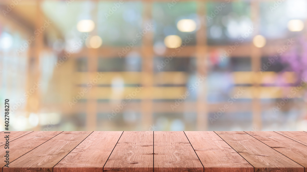 Empty wood table top and blur glass window interior restaurant and cafe banner mock up background - can used for display or montage your products.