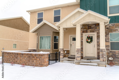 Exterior view of an apartment building with porch bay window and gabled entrance © Jason