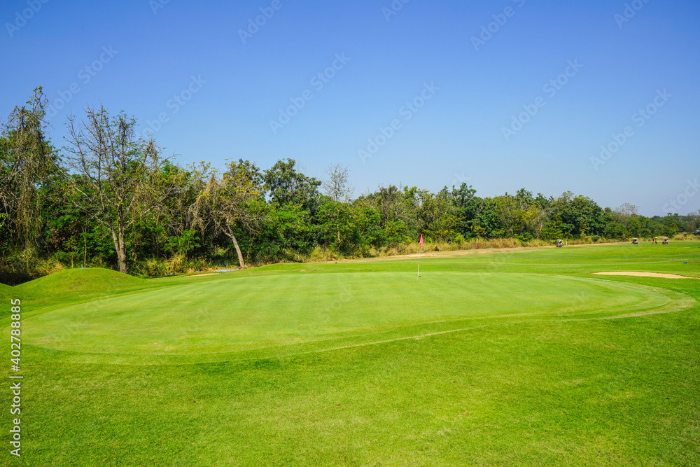 Beautiful golf course in a sunny day. Background evening golf course has sunlight shining down. Golf course in the countryside
