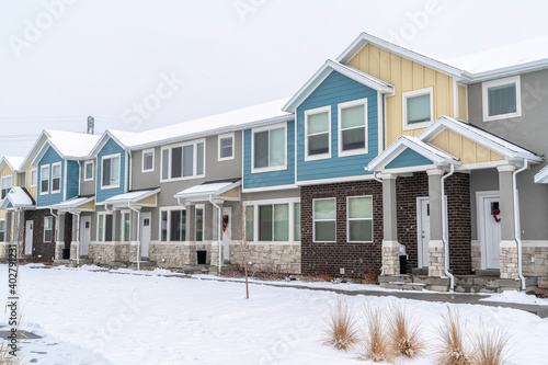Two storey apartments on a beautiful residential landscape with snow in winter