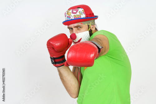The clown plays boxing. Isolated on white