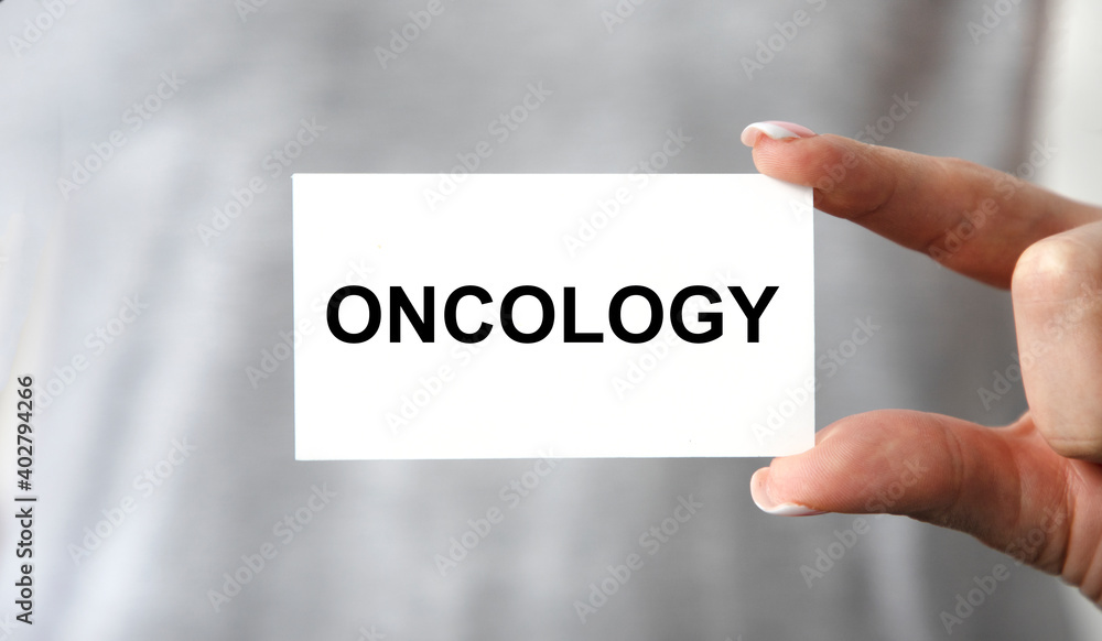 The girl keeps a card with oncology tacts in front of her. The girl keeps a card with oncology tacts in front of her.