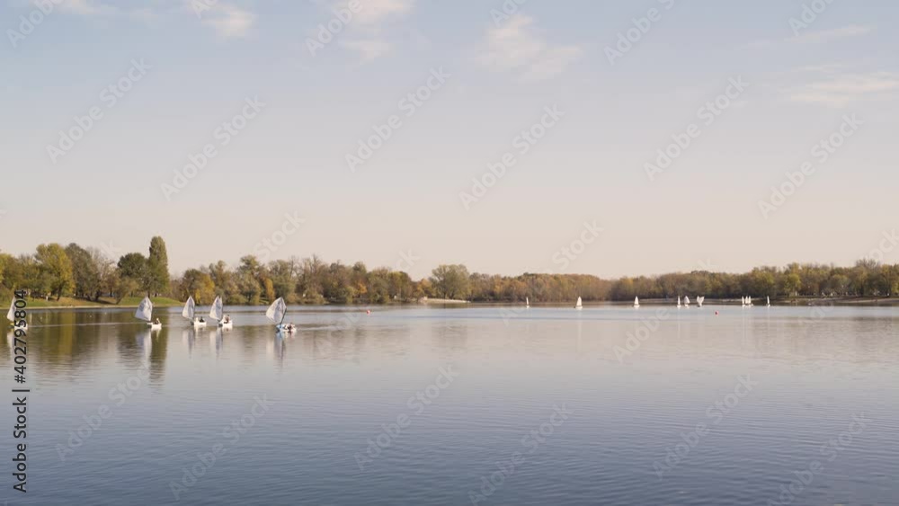Image of windsurfing boats at Jarun lake during autumn, Croatia. Image of windsurfing boats at Jarun lake during autumn, Croatia.