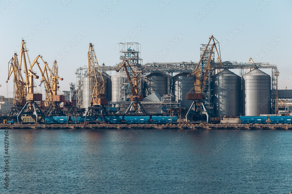 Yellow loading crane. Black Sea commercial port, container loading by crane. Shipping. Container import and export logistics, cargo harbor view. Panorama of harbor cranes. Yellow loading crane. Black Sea commercial port, container loading by crane. Shipping. Container import and export logistics, cargo harbor view. Panorama of harbor cranes.
