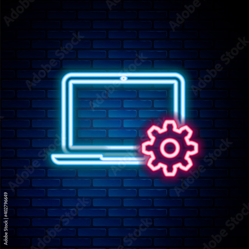 Glowing neon line Laptop and gear icon isolated on brick wall background. Adjusting, service, setting, maintenance, repair, fixing. Colorful outline concept. Vector.