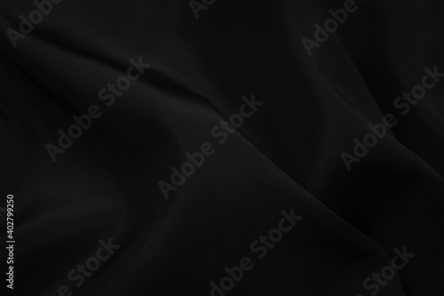 black crinkled material with visible details. background