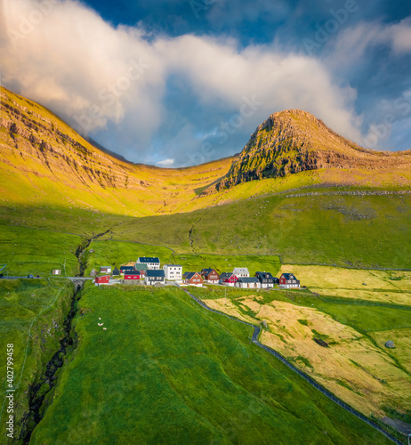 Aerial landscape photography. Bright summer view of Sydradalur village, Kalsoy island. Sunny morning scene of Faroe Islands, Kingdom of Denmark, Europe.  Beautiful summer scenery.. photo