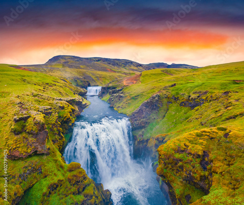 Two cascade waterfall on Skoga river. Amazing summer view from the tourist trek from famous Skogafoss waterfall to the top of the river. Stunning sunrise in Iceland, Europe.