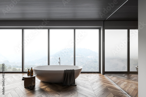 Panoramic gray and wooden bathroom with tub © ImageFlow