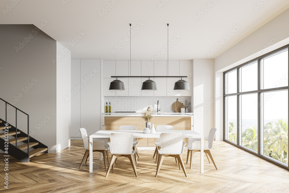 White kitchen with table and stairs White kitchen with table and stairs