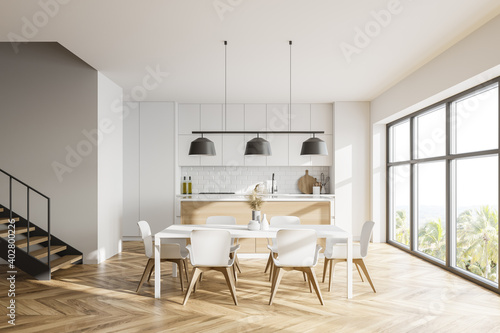 White kitchen with table and stairs © ImageFlow