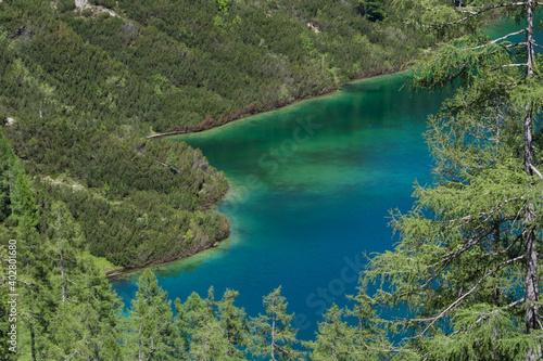 green blue lake in the green nature while hiking in the mountains