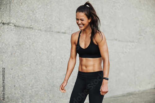 Sporty woman smiling during workout