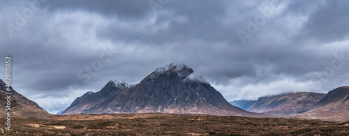 Stunning majestic landscape image of Buachaille Etive Mor and River Etive in Scottish Highlands on a Winter morning with moody sky and lighting © veneratio