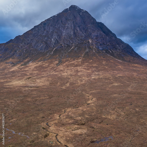 Flying drone epic landscape image of Buachaille Etive Mor and surrounding mountains and valleys in Scottish Highlands on a Winter day