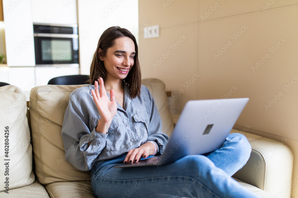 Young happy woman holding video call, gesturing hi to friends, relatives or parents. Attractive female blogger recording new video to followers. Young happy woman holding video call, gesturing hi to friends, relatives or parents. Attractive female blogger recording new video to followers.
