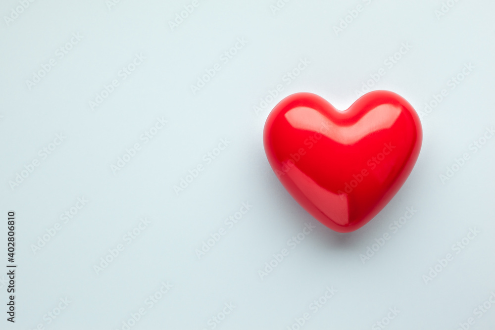 Valentine's day concept with red heart on light blue background, top view, copy space. Valentine's day concept with red heart on light blue background, top view, copy space.