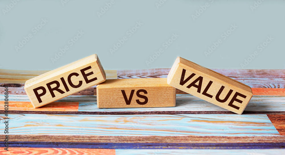 Fototapeta premium Wooden blocks with the inscription Price vs Value on a blue background