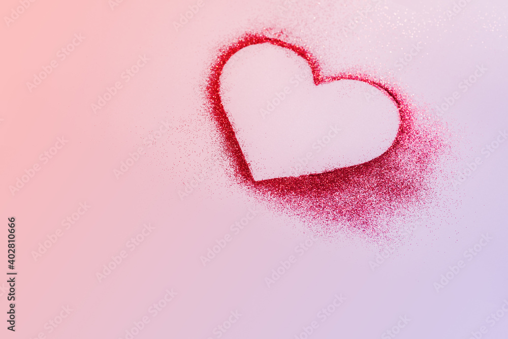 Happy Valentine's Day. Red heart made of glitter on a pastel pink background.Copy space