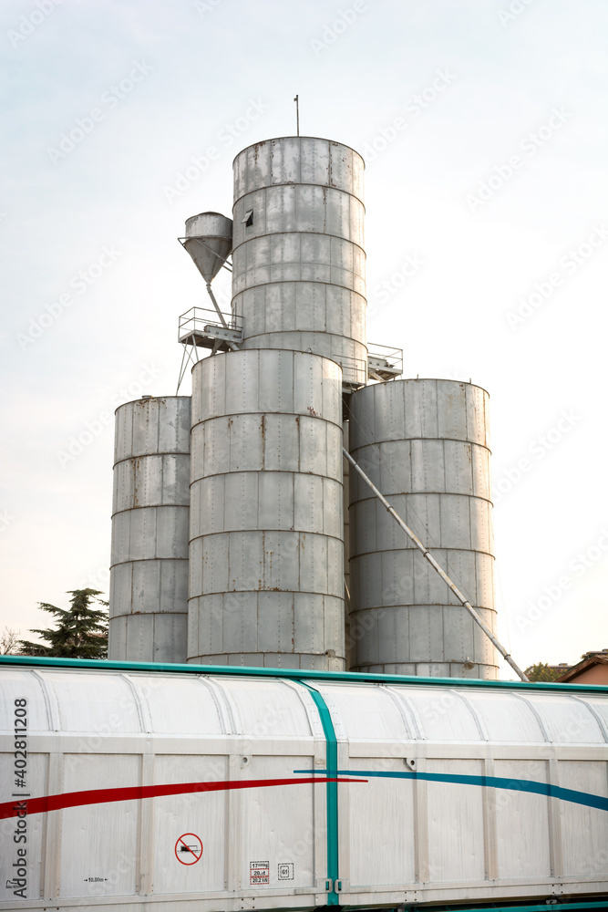 Silo for corn, hazelnuts, legumes and railway wagon behind it Silo for corn, hazelnuts, legumes and railway wagon behind it