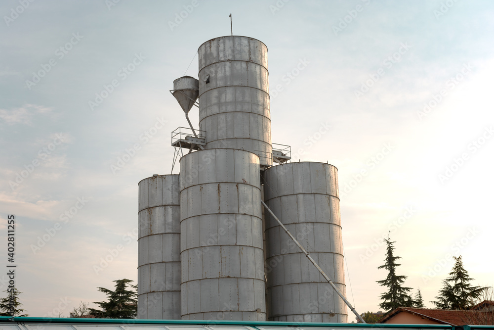 Silo for corn, hazelnuts, legumes against blue sky Silo for corn, hazelnuts, legumes against blue sky
