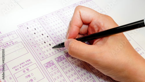 Exam paper, answer sheet with black marker pen. Optional question method test, education system concept, close layout with copy space (Translation: Question, Answer, Type)