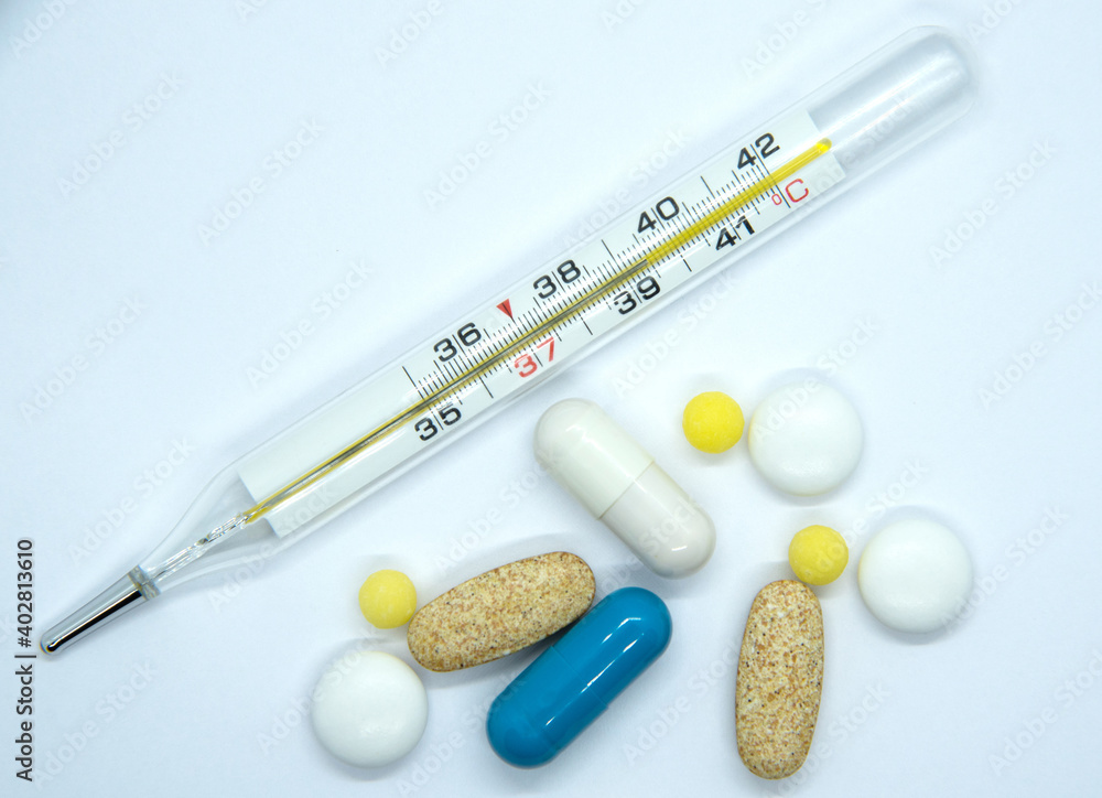 mercury thermometer with medicines on a white background mercury thermometer with medicines on a white background
