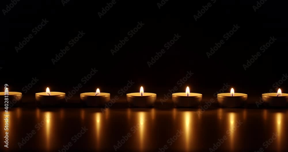 Candles glowing against dark background Candles glowing against dark background
