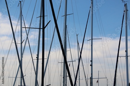 close up of various masts of sailing ships
