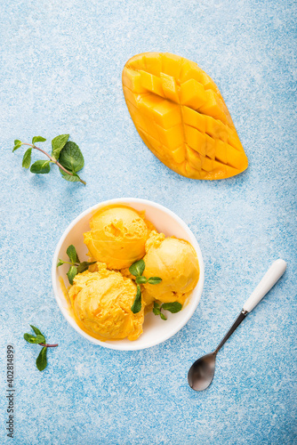 Fotografie Mango ice cream, sorbet in a plate on a concrete background, top view