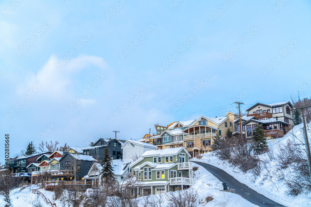 Beautiful houses on a scenic mountain town with snowy nature views in winter