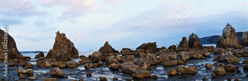 Hashikuiiwa Rocks in a row towering over the seashore from Kushimoto heading towards Oshima in Wakayama, Japan - 橋杭岩 串本町 和歌山県 日本 パノラマ