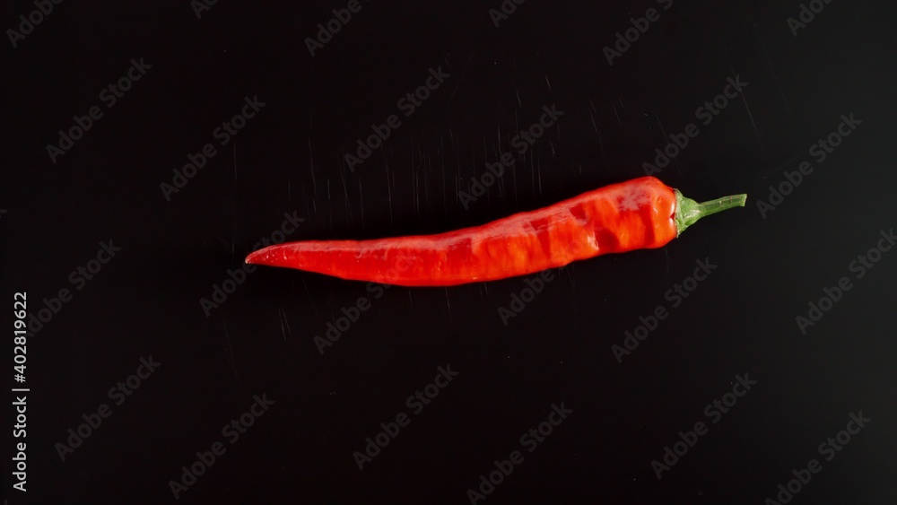 Fresh Red Chili Pepper On A Black Table Fresh Red Chili Pepper On A Black Table