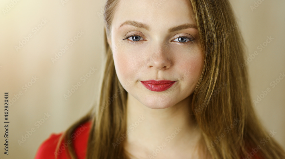 Head shot of a smart confident smiling millennial european woman standing with folded arms at home Head shot of a smart confident smiling millennial european woman standing with folded arms at home